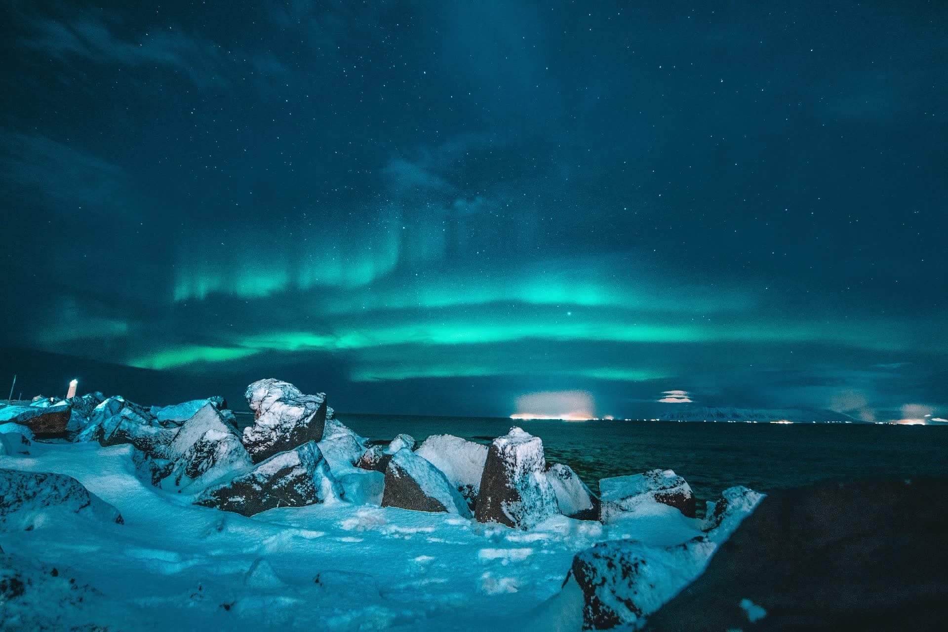 Aurore boréale au-dessus d'un lagon glaciaire, en Islande. Vivre en Islande : notre fiche expatriation.