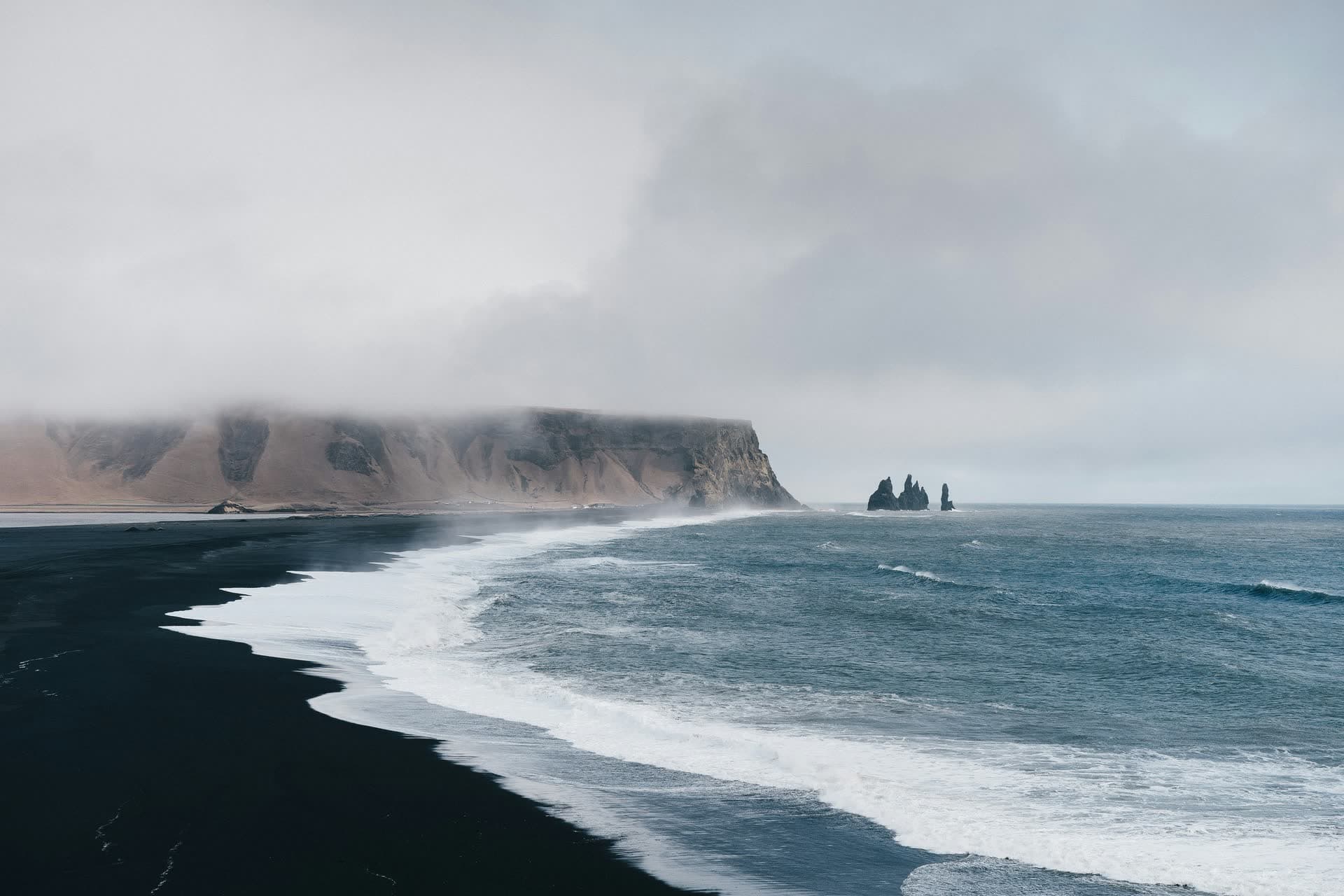 Plage de sable noir battue par les vagues, en Islande